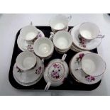 A tray containing 33 pieces of English pink rose patterned bone tea china.