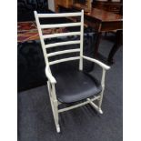 A painted 20th century ladder back rocking chair.
