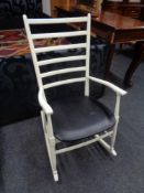 A painted 20th century ladder back rocking chair.