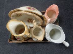 A box containing antique pottery wash jugs and basins.