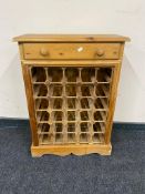 A pine wine rack fitted a drawer