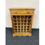 A pine wine rack fitted a drawer