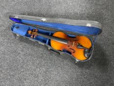 A Chinese violin and bow in case.