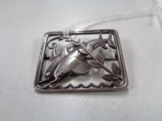 A Georg Jensen sterling silver brooch modelled as two dolphins, 37 mm x 30 mm, numbered 251.