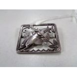 A Georg Jensen sterling silver brooch modelled as two dolphins, 37 mm x 30 mm, numbered 251.