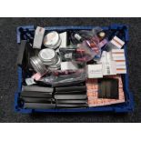A box containing a large quantity of assorted makeup to include lip glosses, shea butter,