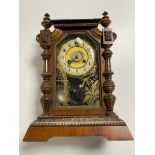 An antique pine cased Junghans bracket clock with brass and enamelled dial,