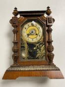 An antique pine cased Junghans bracket clock with brass and enamelled dial,