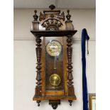 An early 20th century eight day wall clock with brass dial.