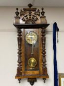 An early 20th century eight day wall clock with brass dial.