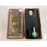 A mid 20th century tin plate coffin bank, boxed.