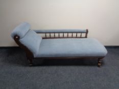 An antique mahogany framed chaise longue upholstered in blue dralon