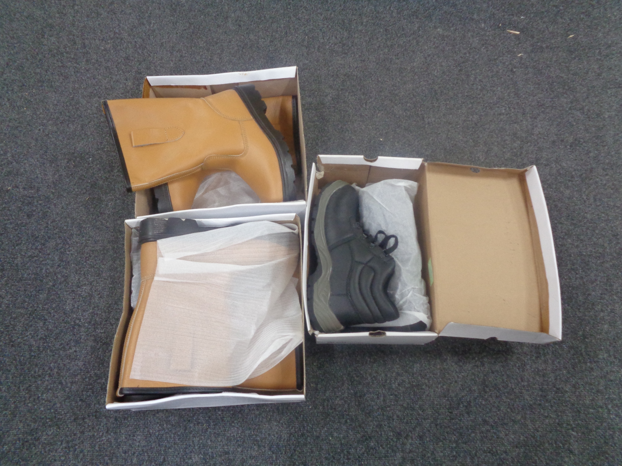 A box containing five pairs of boxed safety boots.