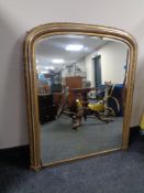 A Victorian gilt framed arch topped overmantel mirror.