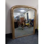 A Victorian gilt framed arch topped overmantel mirror.