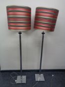 A good quality pair of contemporary chrome standard lamps with shades.