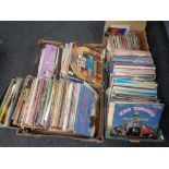 Four boxes containing a large quantity of vinyl LPs and 45 singles to include World Music