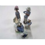 Five Nao figures to include girl with book, girl with puppy, puppies in basket, clown,