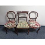 A pair of Victorian mahogany balloon back chairs together with a further antique mahogany chair
