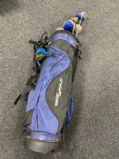 A golf bag containing five assorted drivers to include Triumph and Dunlop,