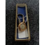 An antique 9ct gold Elgin wristwatch, on later expansion strap.