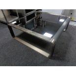 A contemporary metal framed coffee table.