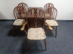 An oak gateleg table and a set of five Windsor chairs comprising one carver and four singles