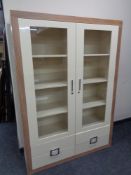 A good quality contemporary wood framed display cabinet with cream high gloss double doors,
