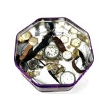A quantity of wristwatches and pocket watches in tin