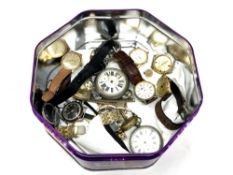 A quantity of wristwatches and pocket watches in tin