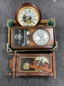 A box containing three wall clocks.