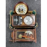 A box containing three wall clocks.