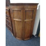 A 19th century mahogany bowfronted corner cabinet