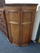 A 19th century mahogany bowfronted corner cabinet