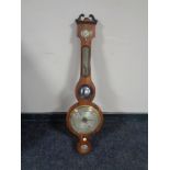 An early 19th century mahogany cased banjo barometer with silvered dial