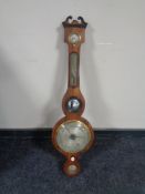 An early 19th century mahogany cased banjo barometer with silvered dial