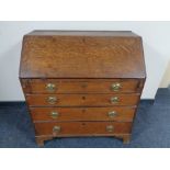 A 19th century oak writing bureau, fitted four drawers.