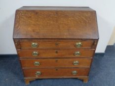 A 19th century oak writing bureau, fitted four drawers.