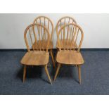 A set of four Ercol elm spindle back chairs