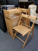 A set of eight folding Ikea kitchen chairs.