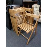 A set of eight folding Ikea kitchen chairs.