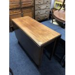 A 19th century mahogany drop leaf table.