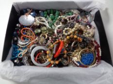 A box containing a quantity of costume jewellery to include beaded necklaces, bangles, brooches,
