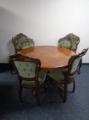 A circular Italianate pedestal table together with a set of four chairs upholstered in a green