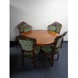 A circular Italianate pedestal table together with a set of four chairs upholstered in a green