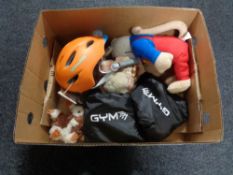 A box containing soft toys, safety helmets, resistance bands.