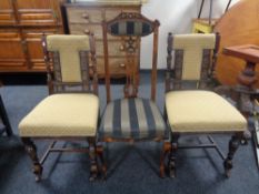 A pair of carved Edwardian dining chairs together with a further antique dining chair.