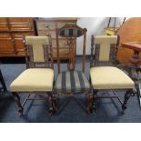 A pair of carved Edwardian dining chairs together with a further antique dining chair.