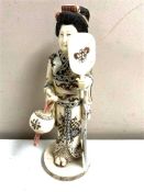 A Japanese carved bone and penwork okimono, Geisha, height 21.