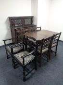 An eight piece dining room suite comprising of buffet back sideboard,